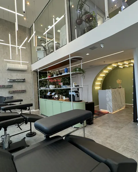 Studio reception with a mezzanine, plants and a light counter.