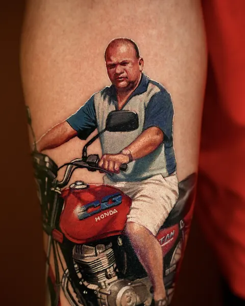 Man sitting on a red motorcycle, color tattoo on the leg.